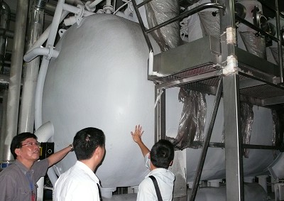 A close-look for three men checking a machine